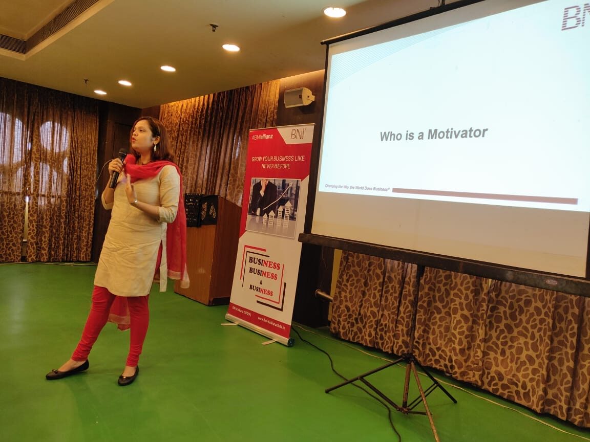Sudakshina speaking on stage at a BNI event