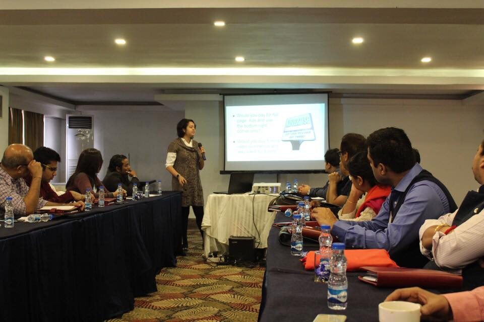 Sudakshina speaking to an audience at a conference